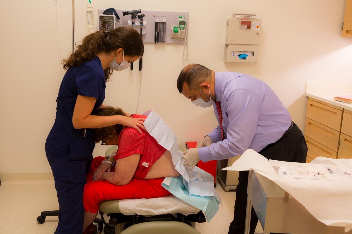 Dr. Saud A. Sadiq performs a lumbar puncture