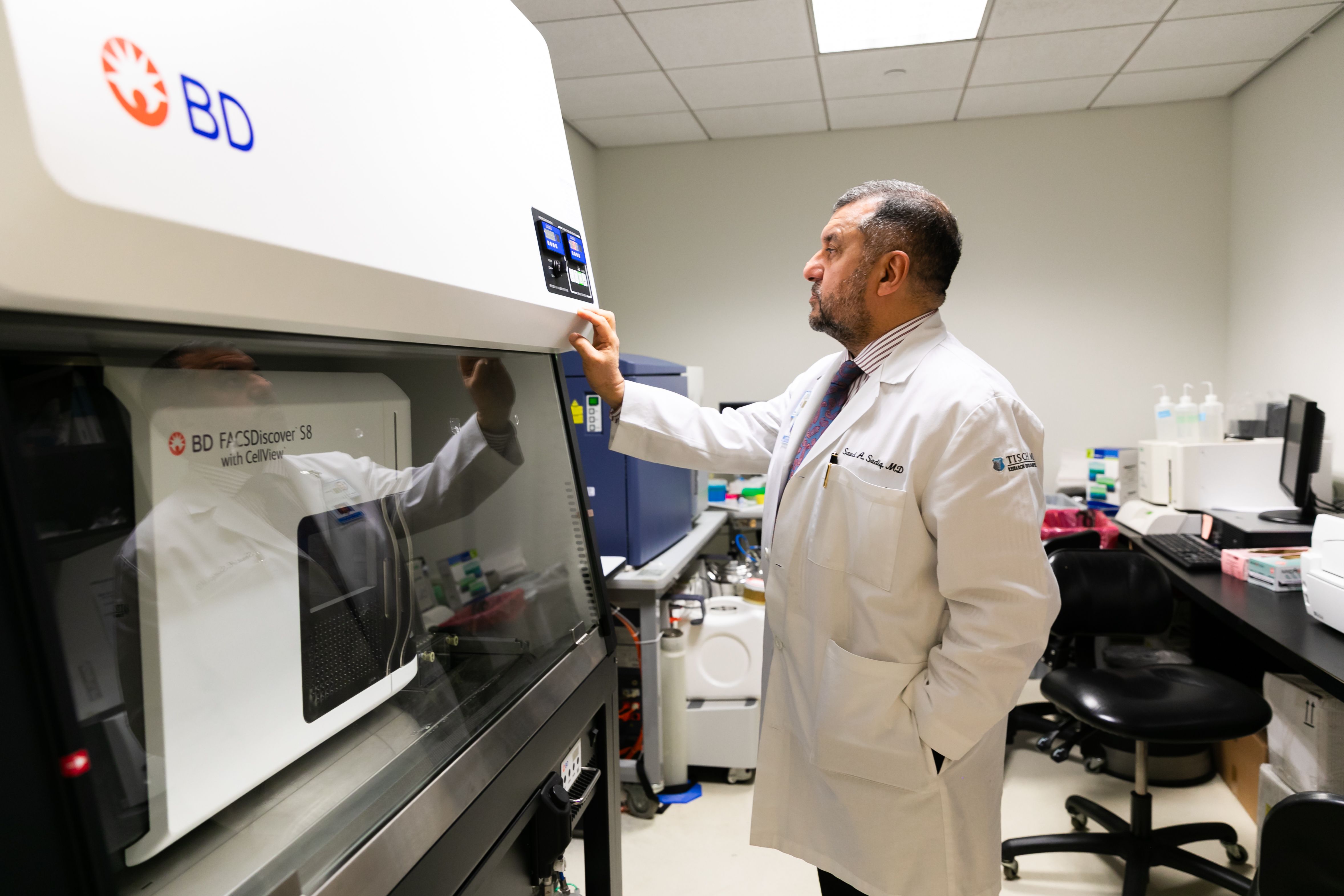 Dr. Sadiq looks at a piece of equioment